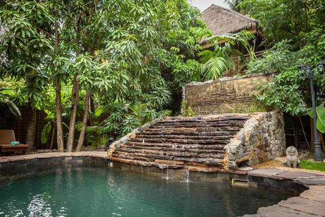 Stone steps and a waterfall into the garden pool