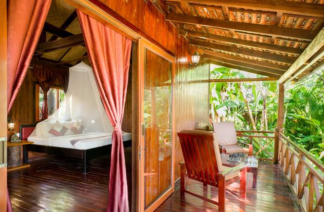 Terrace bungalow bedroom opening onto its veranda