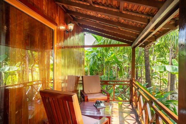 Wooden veranda of a terrace bungalow facing the garden
