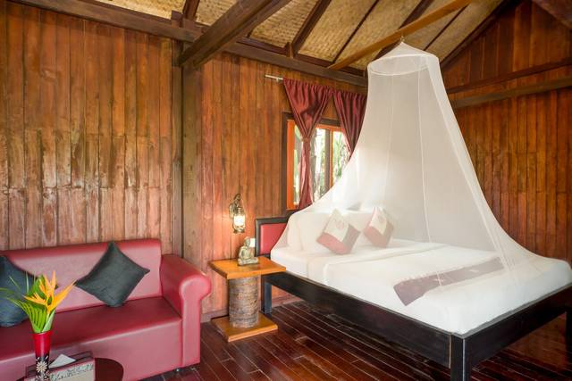 Terrace bungalow bedroom with a canopy mosquito net